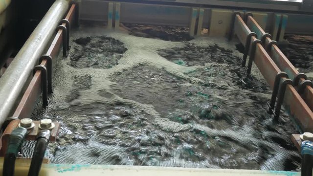 Galvanic bath, Engineering production. Circuit board in galvanic bath in the workflow