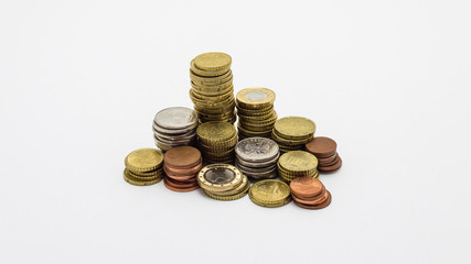Stack of gold and silver coins isolated on white background with clipping path (without a shadow). Growing and saving money concept.