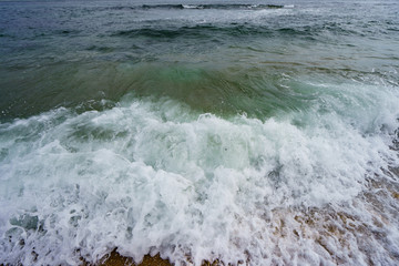 Noisy ocean surf with force throws waves to shore