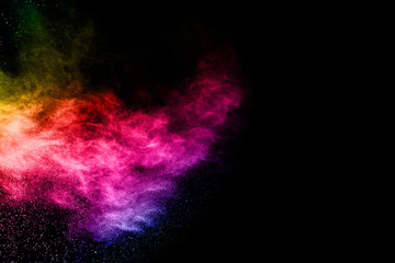 Multicolor powder explosion on black background. 