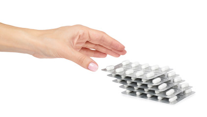 Silver blister packs pills with hand isolated on white background