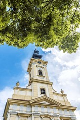 orthodox church building through tree leaves