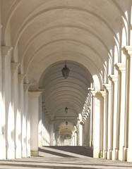 white arcades of a staircase that leads to a Catholic sanctuary