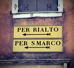 Naklejka premium Venice in Italy and the road sign to Saint Mark square or Rialto