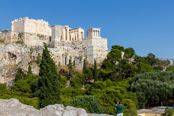 Fototapeta premium Tourist taking a photo of the Acropolis of Athens, Greece