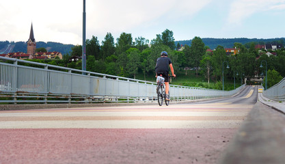 Cyclist passing by on colorful bridge