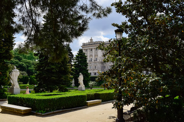 The Royal Palace of Madrid seen through several of its trees. Photograph taken in the gardens of Sabatini in Madrid at the Royal Palace (Spain)