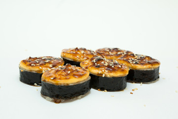 tasty fresh sushi rolls lying on a white background