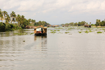 Fototapeta na wymiar Tourist houseboat in Kerala backwaters, India. Travel destination, nature landscape, tourism attraction concept