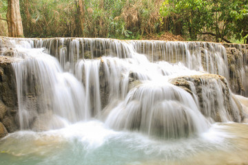 Fototapeta na wymiar Kuang Si Falls nearby Luang Prabang, Laos. Wild forest, nature landscape. Long exposure shot waterfalls