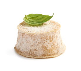 Crottin cheese with basil leave isolated on white background