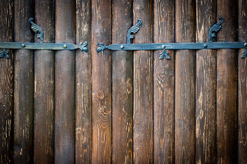 wooden gate with wrought iron elements close up