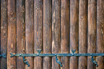 wooden gate with wrought iron elements close up