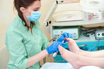 Pedicure dead skin remover foot rasp woman. Professional hardware using electric machine. Patient...