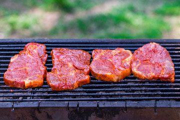 Beef steaks on the grill with flames