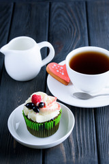 A Cup of fragrant tea with delicious cake in white dish