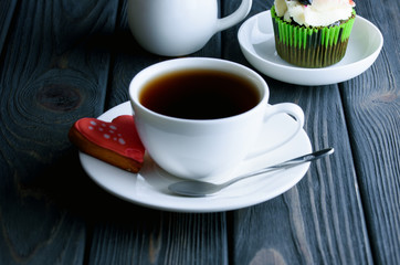 A сup of fragrant tea with delicious cake in white dish