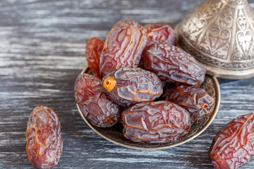 Dried dates on a bronze plate.