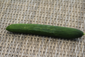 close up of green cucumber on reed background