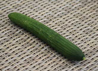 close up of green cucumber on reed background