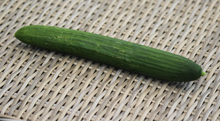 close up of green cucumber on reed background
