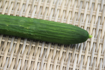 close up of green cucumber on reed background