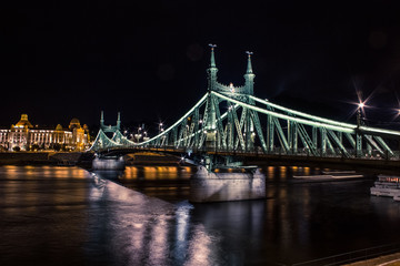 Fototapeta na wymiar night bridge urban colorful cityscape with reflection on river and dark sky
