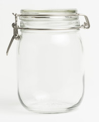 Empty glass food preserving jar in a white kitchen. Potential copy space inside jar.