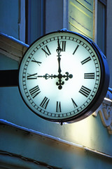 The street clock on the wall at nine o'clock in the evening