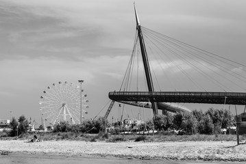 Pescara, Italy - 31 May 2018 - The Ponte del Mare monumental bridge and the Ferris wheel on the beach, in the canal and port of Pescara city, Abruzzo region