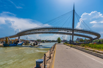 Pescara, Italy - 31 May 2018 - The Ponte del Mare monumental bridge and the Ferris wheel on the beach, in the canal and port of Pescara city, Abruzzo region