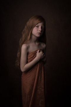 Classic studio portrait of young ginger girl