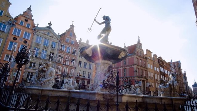 A view of Neptune's Fountain in Gdańsk, Poland with a beautiful sunflare, a historic fountain in Gdańsk located in the most notable part of city - Long Market