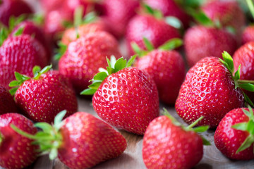 Red strawberry on a wooden table. Farm fruits and berries.