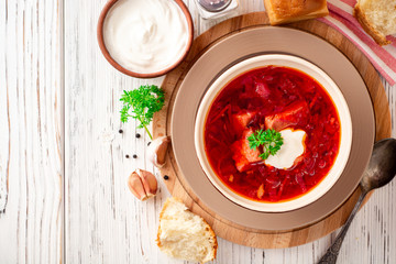 Borsch - traditional Ukrainian and Russian beetroot soup on white wooden background