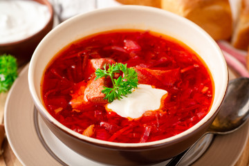 Borsch - traditional Ukrainian and Russian beetroot soup on white wooden background