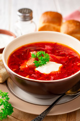 Borsch - traditional Ukrainian and Russian beetroot soup on white wooden background