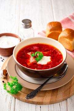 Borsch - traditional Ukrainian and Russian beetroot soup on white wooden background