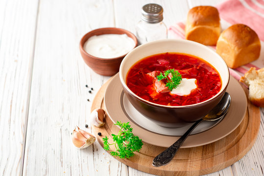 Borsch - traditional Ukrainian and Russian beetroot soup on white wooden background
