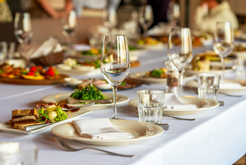 glasses for wine and a beautifully decorated table with snacks in the restaurant