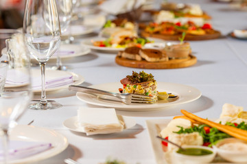 Salad with meat and peas and potatoes dressed with sauce on a beautiful banquet table