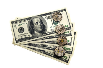 Time is money. The old clock mechanisms are located on dollars. The concept of fast flow of time. Money is killing time. Isolation on a white background.