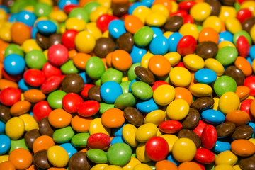 Fototapeta na wymiar Delicious multicolored sweets, sweet and sour. Chocolate, lollipop, gum. Useful and harmful sweets, which are loved by both children and adults. Background.