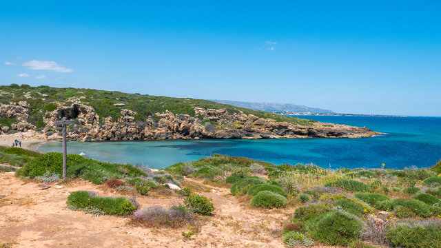 Cala Mosche, Vendicari natural reserve, Sicily, Italy - The perfect beach cove, with turquoise water and typical green bushes of the Mediterranean scrub.