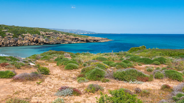 Cala Mosche, Vendicari natural reserve, Sicily, Italy - The perfect beach cove, with turquoise water and typical green bushes of the Mediterranean scrub.