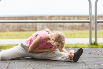 Active woman stretching warming up. Exercise.