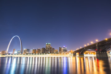 st. louis skyscraper at night with reflection in river,st. louis,missouri,usa.