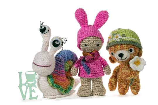 Crochet snail, girl and bear with sign LOVE, on white background. Amigurumi. Handmade