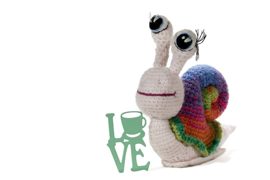 Crochet rainbow snail by sign LOVE, on white background. Amigurumi. Handmade
