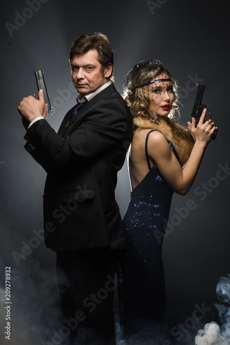 A Pair Of Gangsters A Man And Woman With Guns Stock Photo